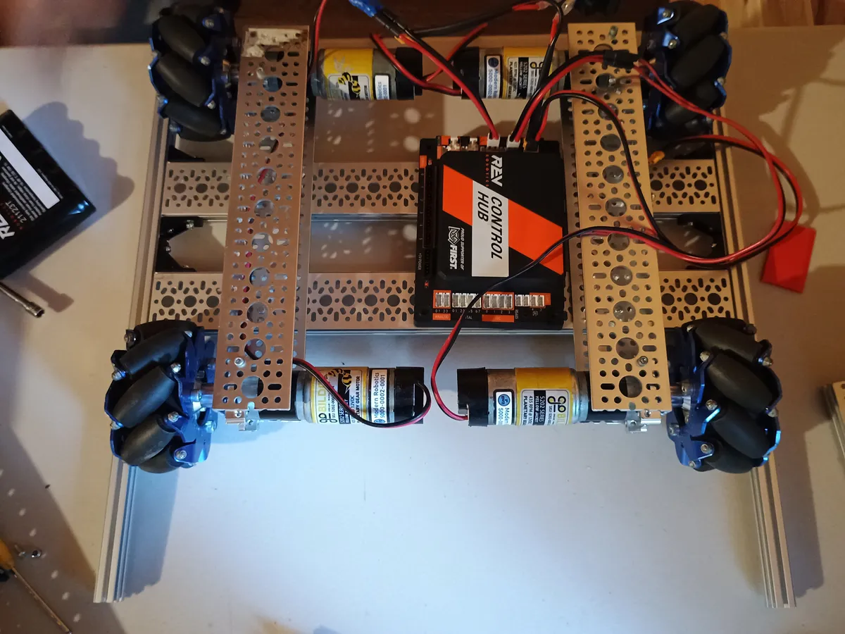 Top view of the narrower chassis with mecanum wheels, drive motors, braces, and the Control Hub