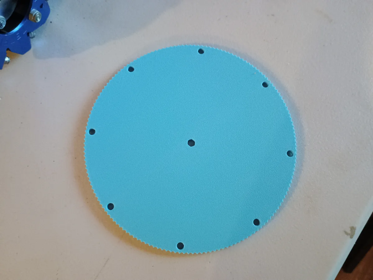 A light blue 3D-printed gear designed in FreeCAD