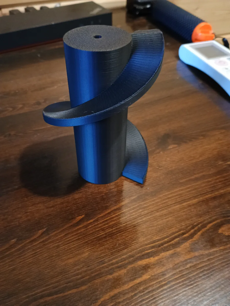 A blue and black 3D-printed screw with the spiral reversed